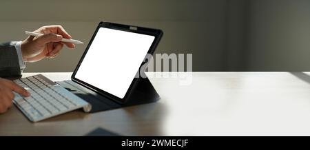 Businessman working using tablet from home office with blank screen for design mockup Stock Photo