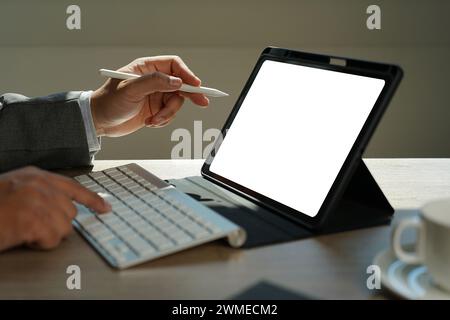 man holding blank screen tablet with isolated screen  at home. Stock Photo