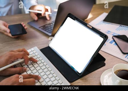 Mockup of a man holds tablet computer with isolated screen  digital tablet with blank screen Mockup replaces your design mockup in the office. Stock Photo