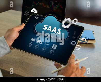 saas cloud Software as a Service saas Internet and technology man On Desktop Computer Stock Photo