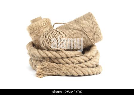 Collection of various rolls of natural jute rough rope and twine arranged on a white surface Stock Photo