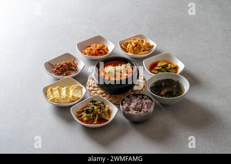 Korean food dish Set Menu of Napa Wraps with Pork Set Menu with Braised Fish Soft Tofu Stew Stir-fried chicken in earthen pot Set Menu with Marinated Stock Photo
