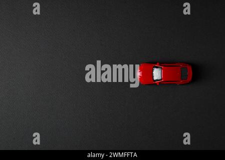 top view of toy red car on dark background Stock Photo