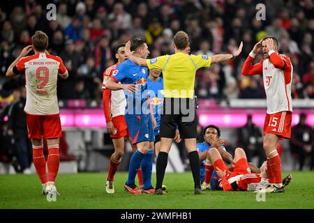 Controversial decision by referee Sascha Stegemann after a tackle, action Lois Openda RasenBallsport Leipzig RBL (17) against Raphael Guerreiro FC Stock Photo