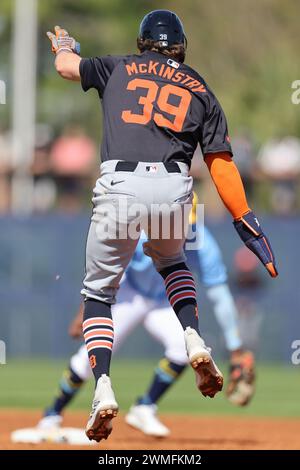 Port Charlotte, FL: Detroit Tigers right fielder Zach McKinstry (39) leaps to avoid a ball while heading to second base during an MLB spring training Stock Photo