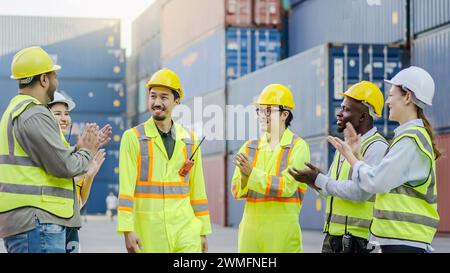 A diverse group of dock workers cheerfully clapping after a productive day Stock Photo