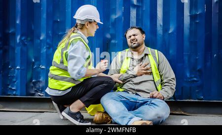 A female dock worker helping her colleague in a container terminal. Thailand, Bangkok Stock Photo