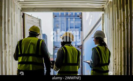 A diverse group of professional dock workers in a container terminal Stock Photo