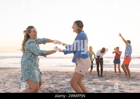 Caucasian couple enjoys a playful moment on the beach, with copy space Stock Photo