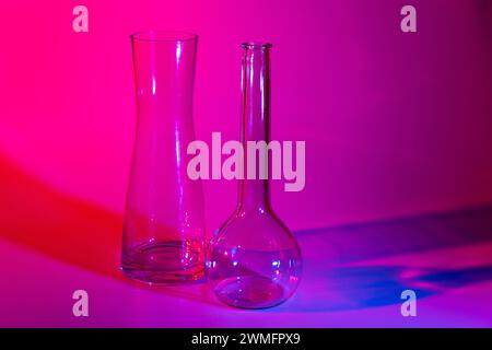 Close-up of two decorative glass vases on a red, blue and violet colored background Stock Photo