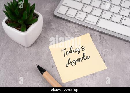 Today's agenda text on sticky note on top of desk Stock Photo