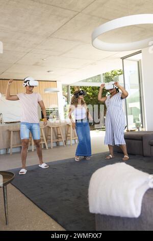 Diverse friends enjoy a virtual reality experience at home Stock Photo