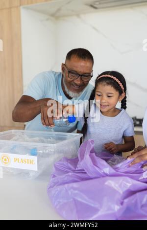 African American grandfather teaches recycling at home Stock Photo