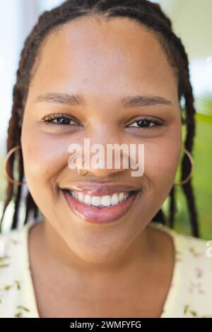 Close-up of a young biracial woman smiling at the camera Stock Photo