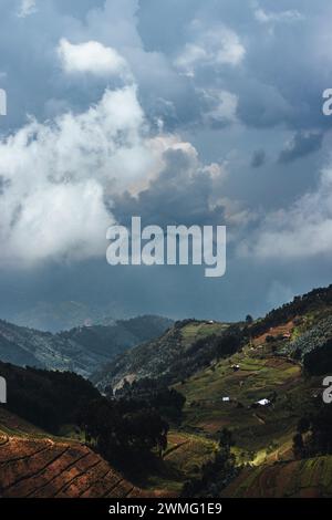 Storm clouds gather over green cultivated hills in Rwanda, Africa Stock Photo