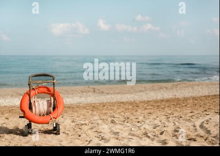 Life buoy ring in a cart on a sandy beach shore on a summer day Stock Photo