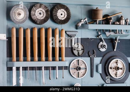 Wall-mounted tool set for lathe in organized workshop Stock Photo