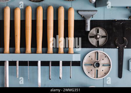 Lathe tools organized on workshop wall Stock Photo