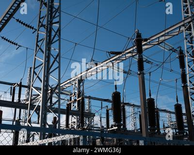 high-voltage power lines of transformer substation against the blue sky Stock Photo