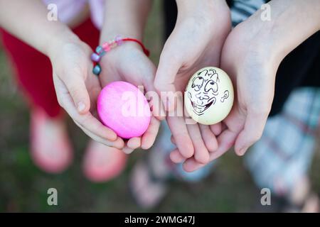 Two Dyed Eggs in the Hands of Children Stock Photo