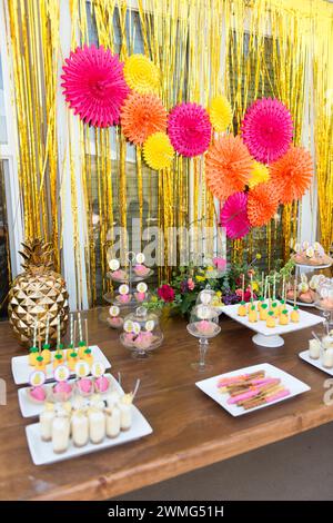 Dessert Table with Pineapple Decorations on a Wooden Table Stock Photo