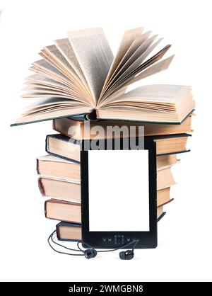 Traditional paper books, e-book and headphones isolated on a white background. Concept of an alternative way of reading books. Stock Photo
