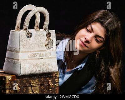 London, UK. 26th Feb, 2024. Christian Dior: a Light Gold and Cream Embroidered Canvas Medium Lady D-Lite Bag, 2021, est £2,500 - £3,000 - A preview of the Designer Handbags and Fashion sale at Bonhams Knightsbridge, London. The sale itself will take place on 28th February in Knightsbridge. Credit: Guy Bell/Alamy Live News Stock Photo