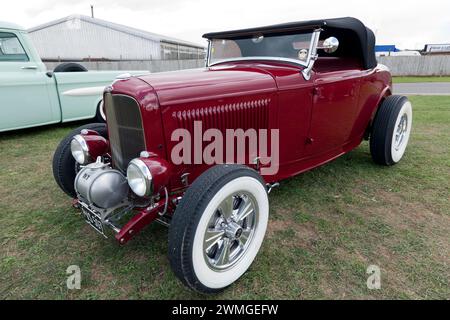 Three-quarter front view of a Red, 1932, Ford Model B Hot-Rod, on display in the Yokahama Shift and Drift Zone, of the 2023 Silverstone Festival Stock Photo