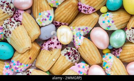 Many beautifully decorated Madeleines with sprinkles for Easter. Stock Photo