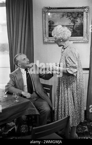 1980s UK. Couple at the Golf Club in their Sunday best clothes chatting together. Didsbury Golf Club.  Didsbury, Manchester, England UK 1981 HOMER SYKES Stock Photo