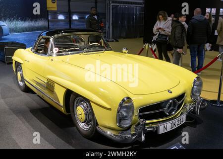 Paris, France - Rétromobile 2023. Focus on a Uranium Yellow 1961 Mercedes-Benz 300 SL Roadster. Stock Photo