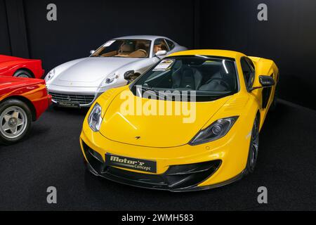 Luxembourg City, Luxembourg - Focus on a yellow McLaren MP4-12C Spider MSO in a showroom. Stock Photo