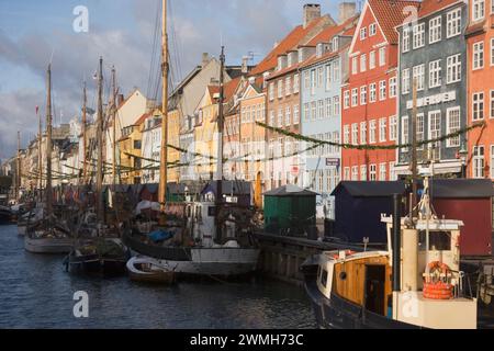 A variety of boats docked closely together in a harbor: Nyhavn Harbour, Copenhagen Stock Photo