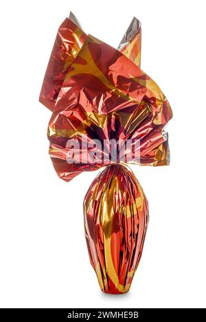 Easter egg wrapped in glittering brown and yellow  paper isolated on white with clipping path included Stock Photo