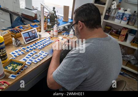 Assembling miniature flowerpots to a fridge magnet of a traditional Cordoba patio.  The historic city of Cordoba in the province of Andalusia in south Stock Photo