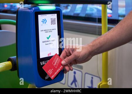 Madrid,Spain;02252024 Passenger using multi card with magnetic contactless tech on the free touristic public bus at Madrid downtown Stock Photo