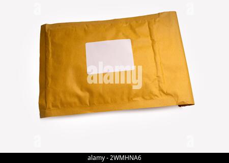 brown paper padded postal envelopes isolated on a white background with blank address label Stock Photo