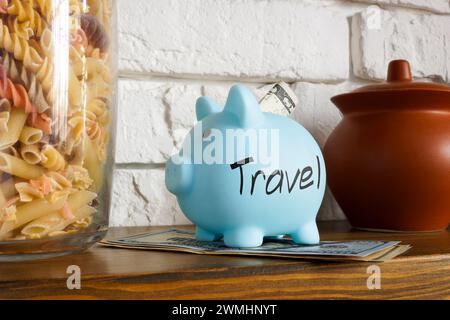 Savings for travel concept. Piggy bank on shelf at home. Stock Photo