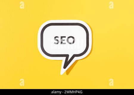 SEO text on speech bubble isolated on yellow background Stock Photo