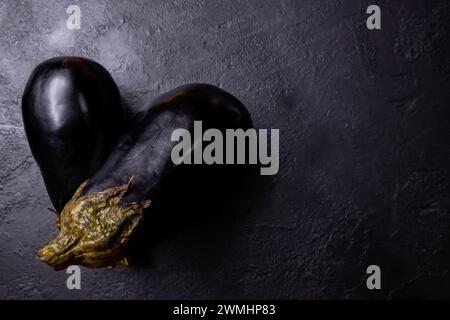 Composition of two eggplants on a dark background. Stock Photo