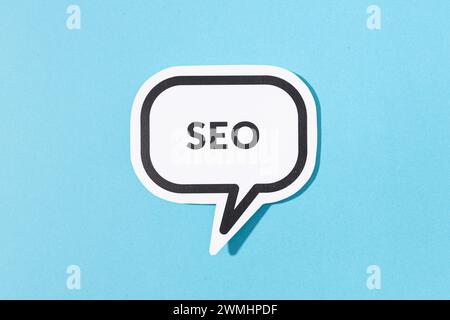 SEO text on speech bubble isolated on blue background Stock Photo