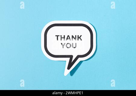 Thank you text on speech bubble isolated on blue background Stock Photo