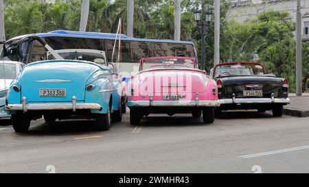 016 Old blue-pink-black almendron cars -yank tank, Ford and Chevrolet American classics from 1947-52-55- on Paseo del Prado promenade. Havana-Cuba. Stock Photo
