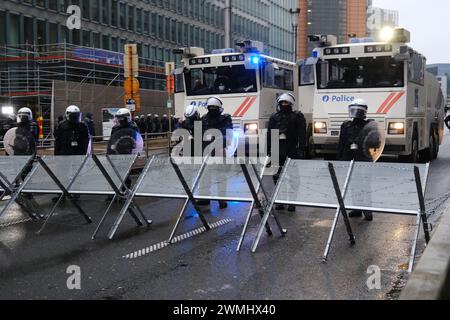 Brussels, Belgium. 26th Feb, 2024. Police stand during a protest of European farmers over price pressures, taxes and green regulation, on the day of an EU Agriculture Ministers meeting in Brussels, Belgium February 26, 2024 Credit: ALEXANDROS MICHAILIDIS/Alamy Live News Stock Photo
