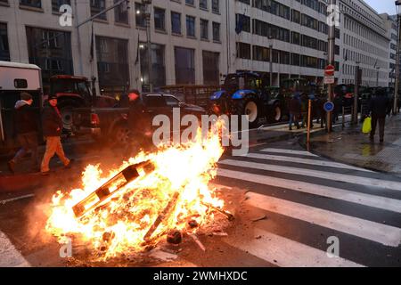 Brussels, Belgium. 26th Feb, 2024. People gather during a protest of European farmers over price pressures, taxes and green regulation, on the day of an EU Agriculture Ministers meeting in Brussels, Belgium February 26, 2024 Credit: ALEXANDROS MICHAILIDIS/Alamy Live News Stock Photo