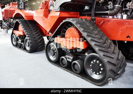 Replaceable continuous track drive for agricultural harvester on exhibition Stock Photo