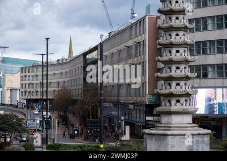 Ringway Centre, a classic of Brutalist architecture which is due to be demolished to make way for flats with the pagoda in the foreground on 26th February 2024 in Birmingham, United Kingdom. Ringway Centre is a Grade B locally listed building located on Smallbrook Queensway in the city centre. The six-storey, 230 metres long building was designed by architect James Roberts as part of the Inner Ring Road scheme in the 1950s and is notable for its gentle sweeping curved frontal elevation. In July 2016, the building was refused listed status by Historic England which enables redevelopment to take Stock Photo