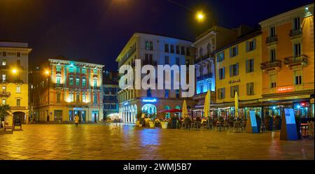 LUGANO, SWITZERLAND - MARCH 17, 2022: The bustling outdoor patios on  Piazza della Riforma at night, on March 17 in Lugano, Switzerland Stock Photo