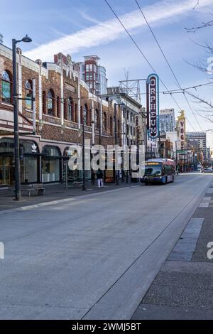 Vancouver, Canada - Feb 9 2024: A view of Granville Street with the Commodore building, the signs of the Orpheum and Vogue theatres, and a bus. Stock Photo