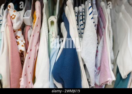 Children clothes hanging on hangers in the shop Stock Photo